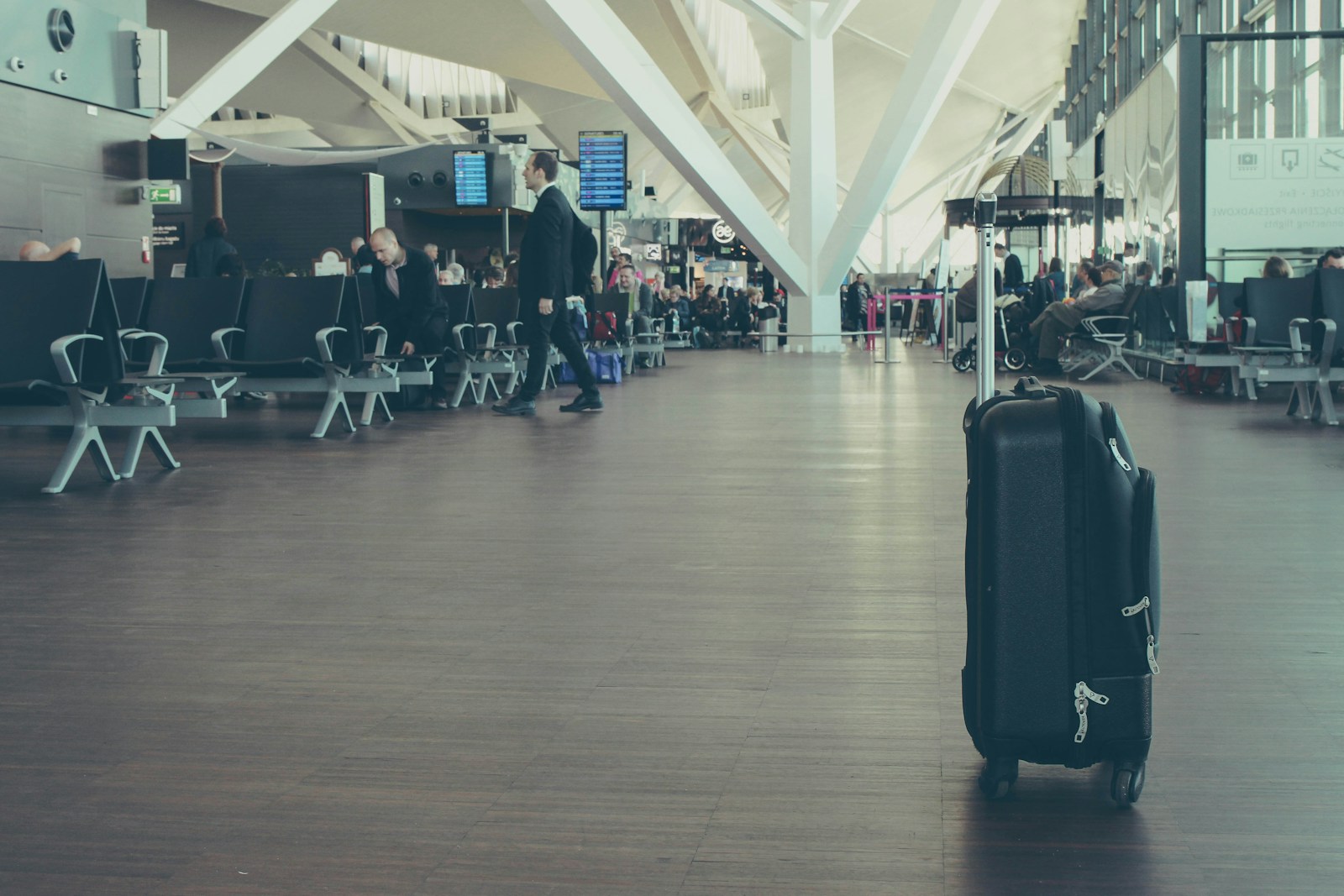 unattended black luggage inside airport