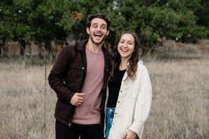 A man and a woman standing in a field